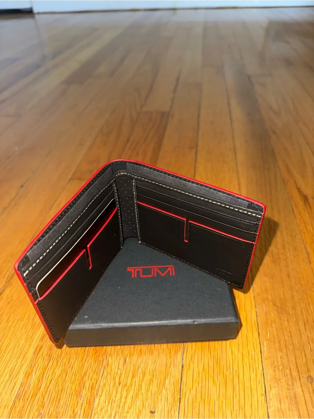 Tumi Black Leather Bifold Wallet with Red Edge